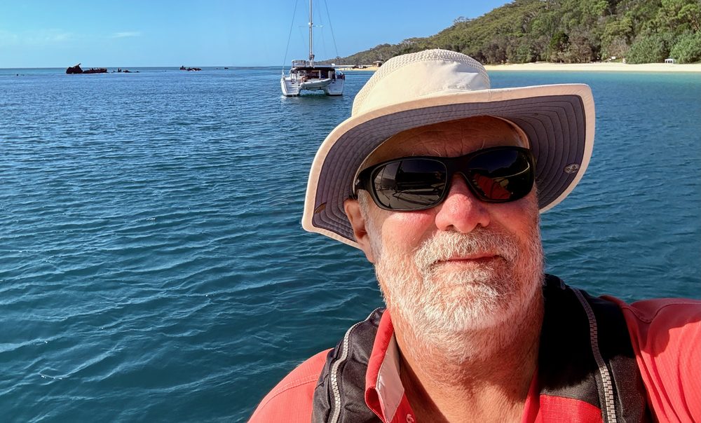 Mark Morwood on Moreton Bay with a catamaran anchored behind